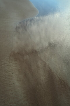 Abstract Wet Sand Texture with Receding Ocean Water on Beach