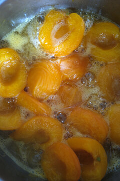 Apricot Halves Simmering in Sweet Syrup for Homemade Jam