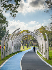 Tranquil Urban Park Path Featuring Unique Architectural Arches