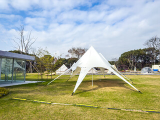 Modern Outdoor Event Tent Set Against a Clear Blue Sky