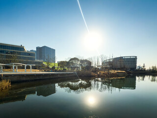 Peaceful Riverside Scene at Sunrise in Urban Setting