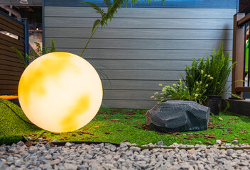 Tranquil Outdoor Oasis Featuring Soft Lighting, Lush Greenery, and Natural Elements