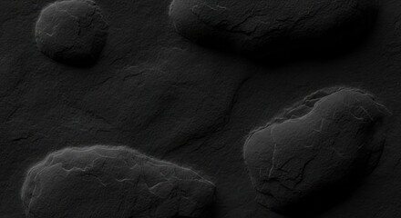 Close-up of dark, rough, rounded rock formations on a textured, flat surface