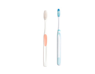 Two clean toothbrushes, one pink, one blue, on black background