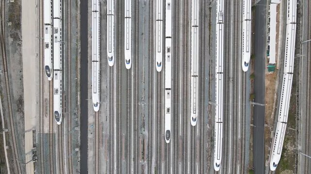 Aerial View of Train Depot with Multiple White High-Speed Trains
