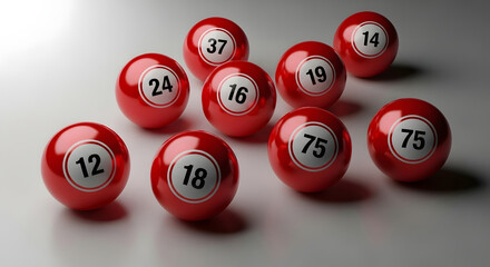 A collection of red bingo balls with white numbers displayed on a gray surface