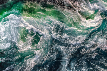 Plakat Blue waves of water of the river and the sea meet each other during high tide and low tide.