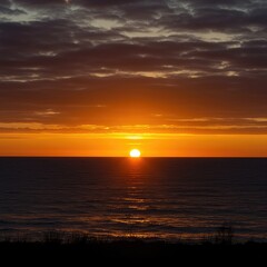 Obraz premium Brilliant golden hour illumination painting the wide expansive sky with fiery colors as the sun dips below the natural horizon line ,radiance ,abstract ,natural