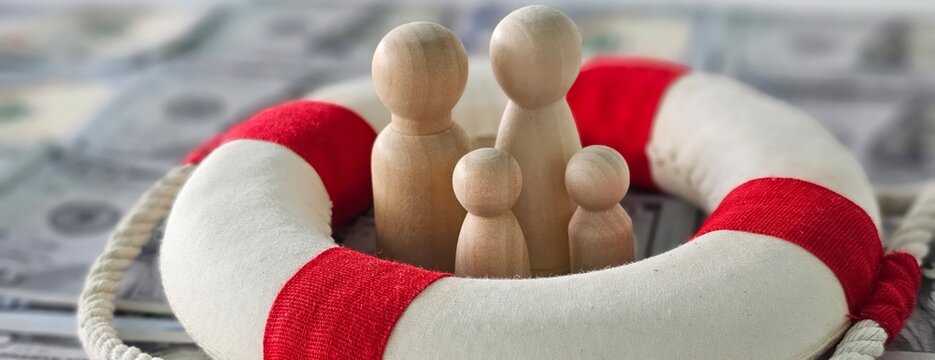 A lifebuoy surrounds wooden figures representing family on a backdrop of hundred-dollar