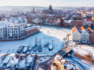 Hundreds of people walk along the frozen Motława River in Gdańsk during a frosty winter. Poland