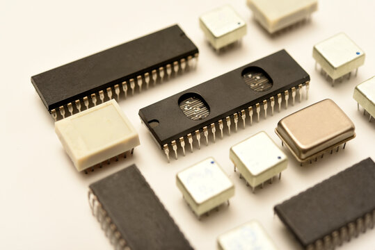 Old chips on a white background. Electronic components. Processors in metal and plastic cases.