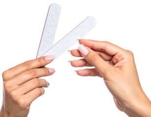 Woman's hands filing nails with two boards, on white. Manicured, pale pink polished nails
