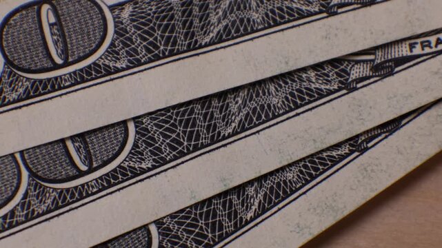 Money in detail showing texture and design of 100 dollar bills with focus on Franklin