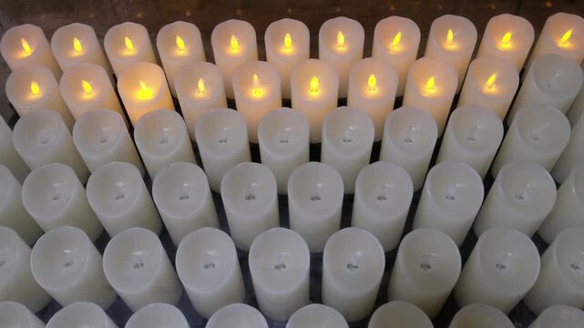 Array of Battery Operated Candles Flicker in the Dim Light. 70 char max
