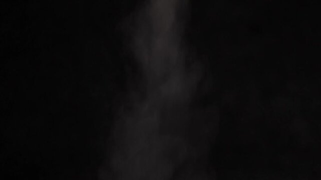 Smoke rises in dark space during artistic expression in a creative project