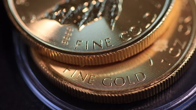 Two gold coins lying on top of each other, illustrating the concept of rising gold prices, futures contracts or gold funds, and gold as a safe-haven financial asset.