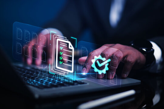 A businessman working with laptops, digital documents, checklist interfaces, and document management processes for quality control approval, data organization, a paperless office, and business process