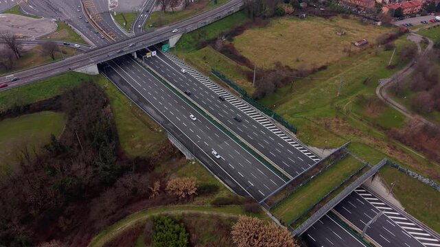 Wildlife overpass crossing a multi-lane highway aerial view