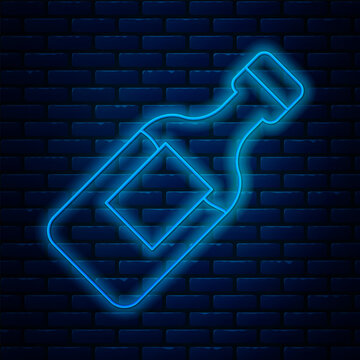 Glowing neon line Bottle of water icon isolated on brick wall background. Soda aqua drink sign. Vector