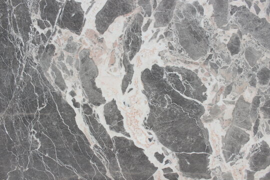 Breccia Grigio marble texture featuring grey rock fragments and thick, dynamic creamy white veins.