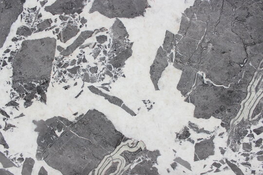 Invisible Grey marble texture with large dark grey brecciated patterns on a crystal white base.
