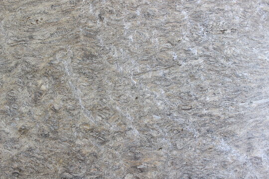 Grey granite stone texture with fine and dense natural mineral spots for outdoor area use.