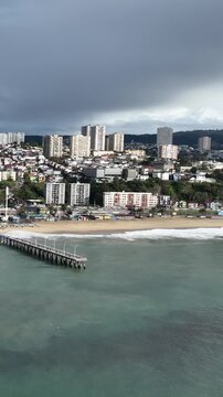 Vina del Mar in Chile with a rainbow. Beautiful aerial image of the coastline. Aerial view, vertical video