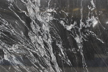 Fototapeta premium Detailed texture of Copacabana marble with black to grey color gradations and highly expressive white vein patterns for interior decoration.