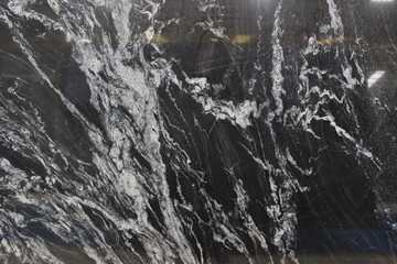 Fototapeta premium Copacabana black marble texture with expressive white vein patterns and sharp contrast, exotic natural stone from Brazil for wall and floor.