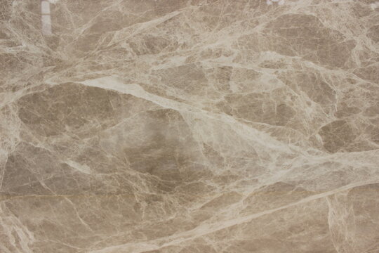 Detail of polished Tundra Grey marble showing the beauty of white calcite veins on a grey stone surface.