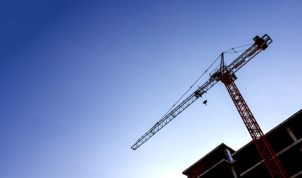 Tower Crane at Construction Site with Clear Blue Sky and Copy Space