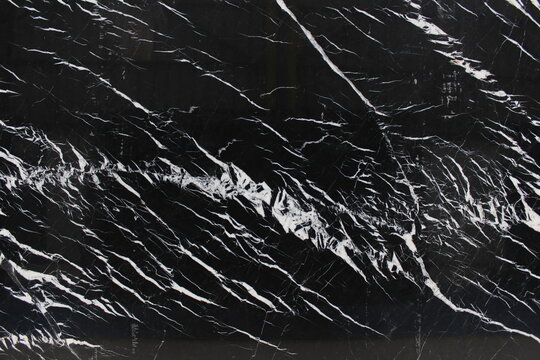 Nero Marquina black marble texture with sharp white veins, elegant high contrast for luxury interior design.