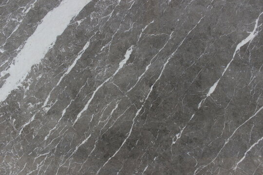 Texture of Grigio Carnico marble from Italy in dark grey with contrasting and elegant thick white veins for interior materials.