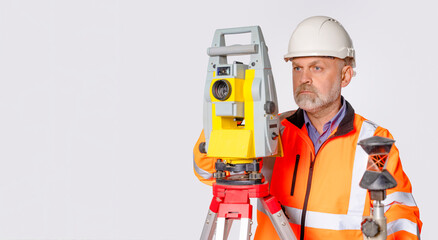 Fototapeta premium Worker uses surveying equipment for land measurement and analysis in a controlled setting indoors