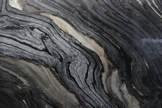 Black Forest marble texture with intense black and dark grey vein flow patterns resembling natural wood grain.