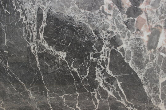 Close up of Grigio Carnico marble with strong grey and white breccia patterns for artistic interior wall applications.