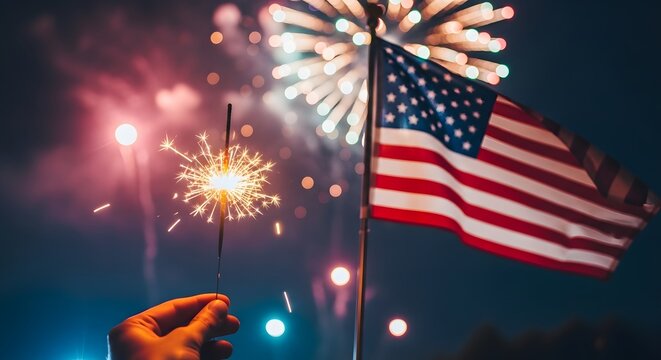 Vibrant fireworks display beside a waving american flag at night