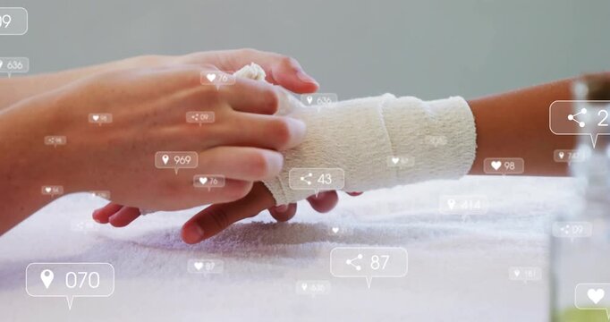 Caregiver placing child's hand on towel, wrapping gauze arm for health with floating icons over arm