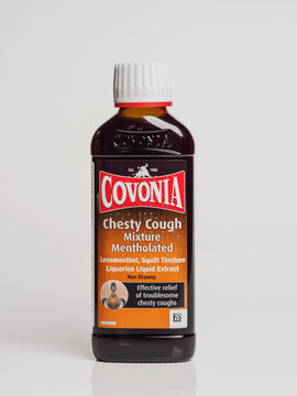 Bottle of Covonia chesty cough medicine with mentholated formula on a white background.