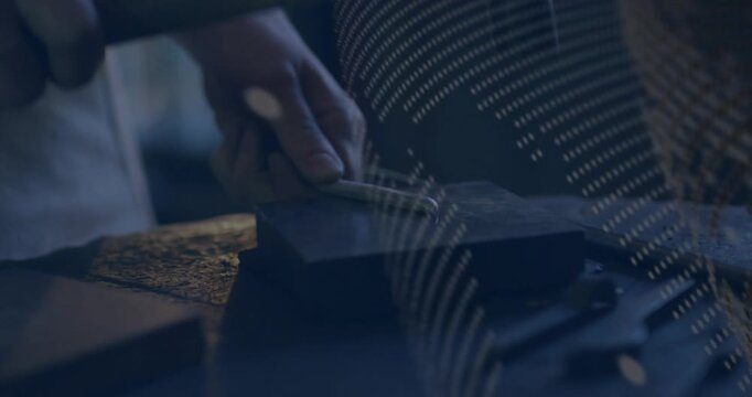 Female smith placing rod on block, hammer tapping shaping rod while panel shifting, obscuring hands