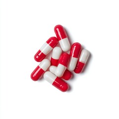Red and White Capsules on White Background Ideal for Medical, Pharmaceutical and Health-Related Visual Content