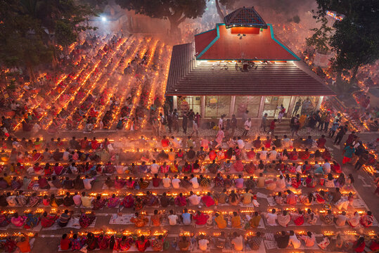 Narayanganj, Bangladesh - 11 November 2025: Aerial view of a sea of devotees bathed in the warm glow of countless diyas near the serene temple complex.