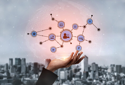 A creative representation of digital connections through a hand gesturing towards various network icons, symbolizing technology and communication in a vibrant cityscape. Tessel