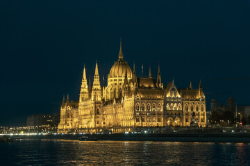 Fototapeta premium Illuminated Hungarian Parliament Building and Danube river at the night. Budapest capital od Hungary.