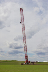 crane moving across farm field