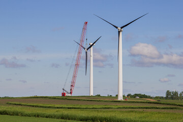 crane pulling blades off a wind turbine