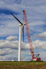 crane pulling blades off a wind turbine