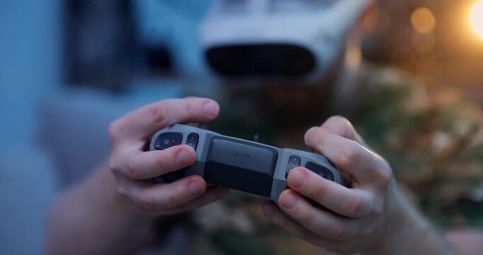 Man in camo attire use rc for training simulation fly on FPV drone in VR glasses, Immersive virtual reality.