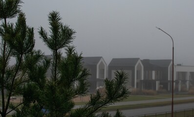 View of the roofs of new houses during fog