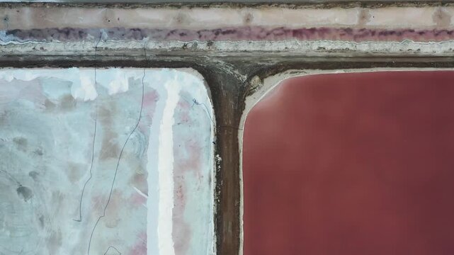 Aerial view of vivid salt ponds showcasing stark color contrasts, from pale blues to deep pinks, creating a striking visual texture, Eilat, South District, Israel.